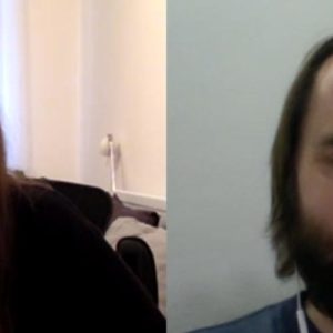 Image contains a photo of a video chat between a man and a woman. On the right, the man is smiling and looking to the right. On the left, the woman is smiling as well.
